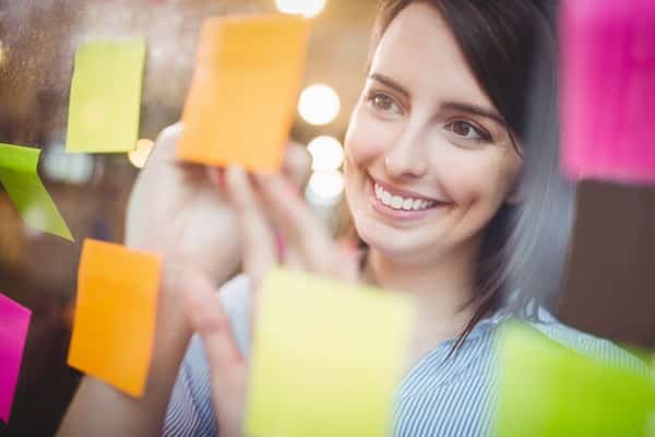 creative businesswoman writing- sticky notes - Understanding Self-management Skills Training Course