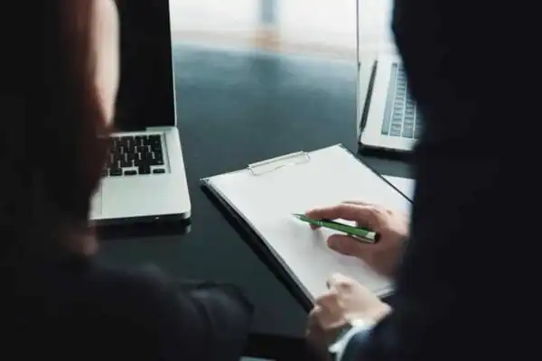 people at a desk with computer and clipboard Disciplinary Investigation course