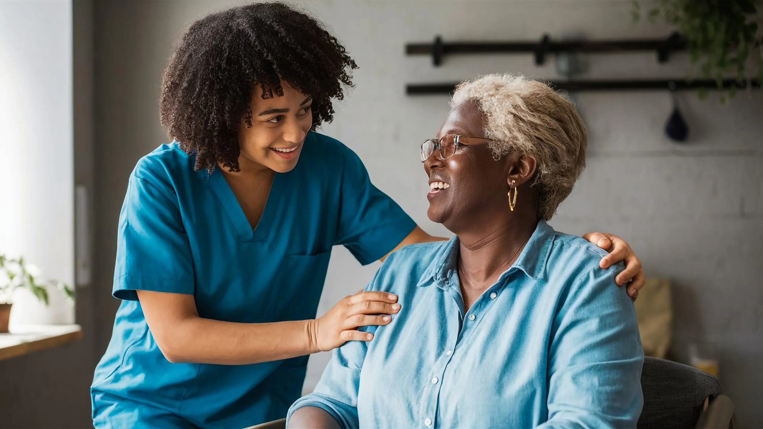 female carer and patient smiling Suprapubic Catheter Care