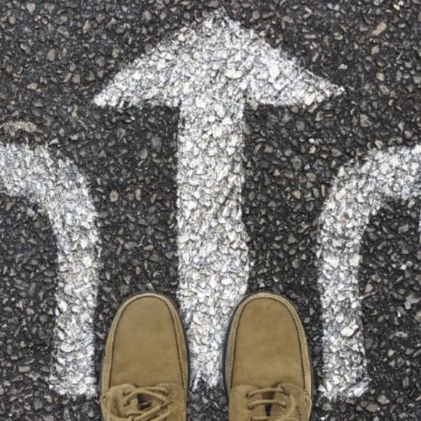 Mental Capacity Act and Deprivation of Liberty Standards person standing on a road surface with arrows depicting a choice in direction